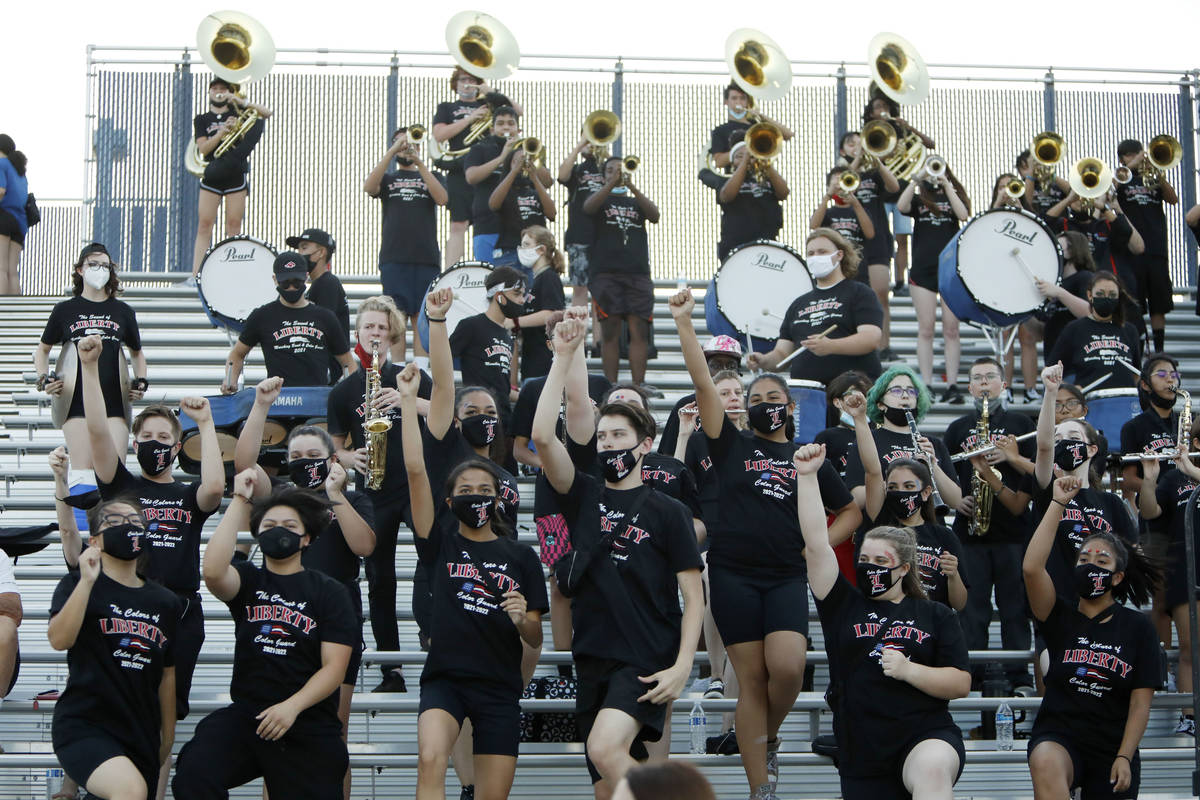 Liberty High School marching band performs during the first half of a football game against Arb ...