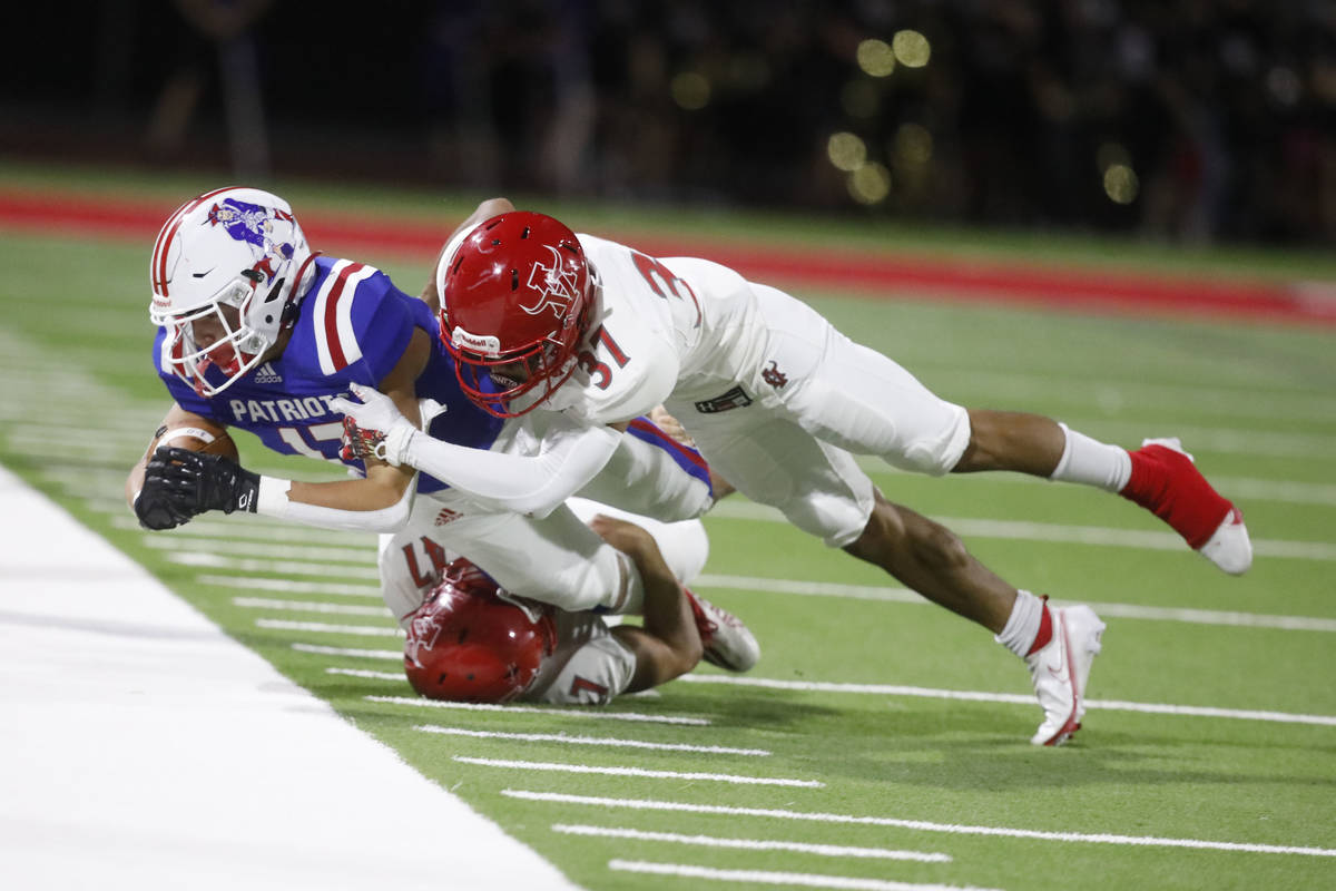 Liberty High Schoolճ Colin Gregorio (17) is tackled by Arbor View High School's Bryce Eri ...