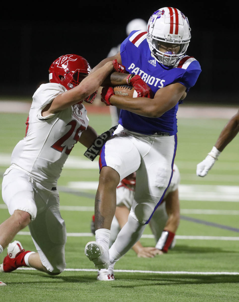 Liberty High School's Larry Royal (3) is tackled by Arbor View High School's Tanner Aitken (25 ...