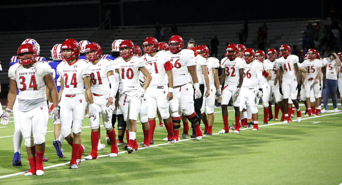 Arbor View High School players shake hands with Liberty High School players after a football ga ...