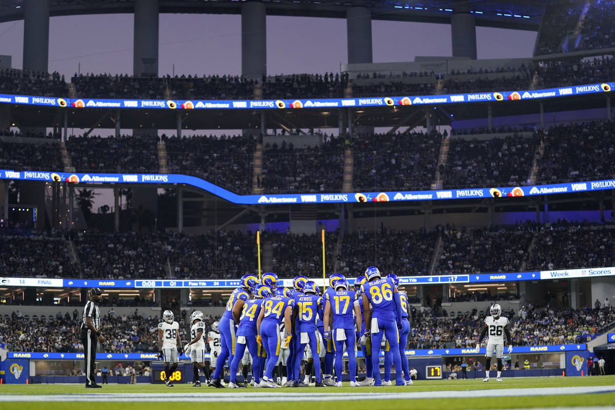The Los Angeles Rams huddle during the first half of a preseason NFL football game against the ...
