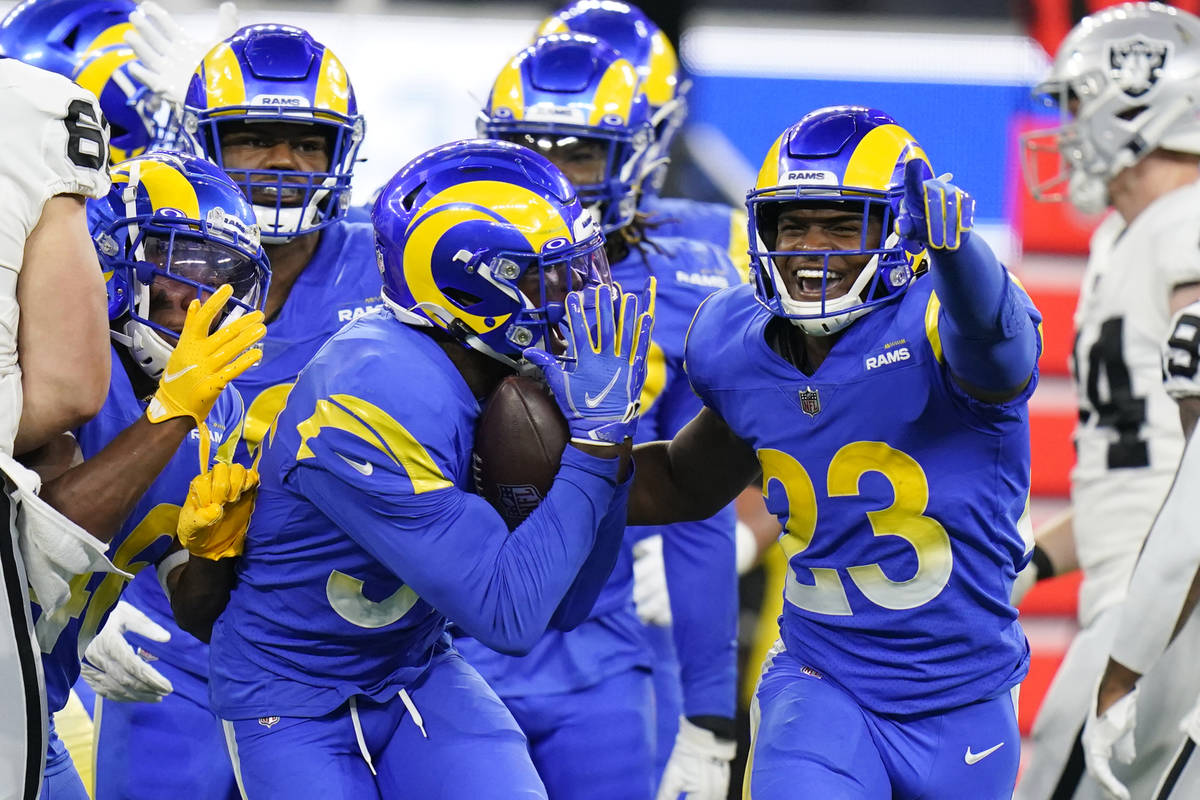 Los Angeles Rams safety J.R. Reed, left, celebrates his interception with JuJu Hughes (23) duri ...
