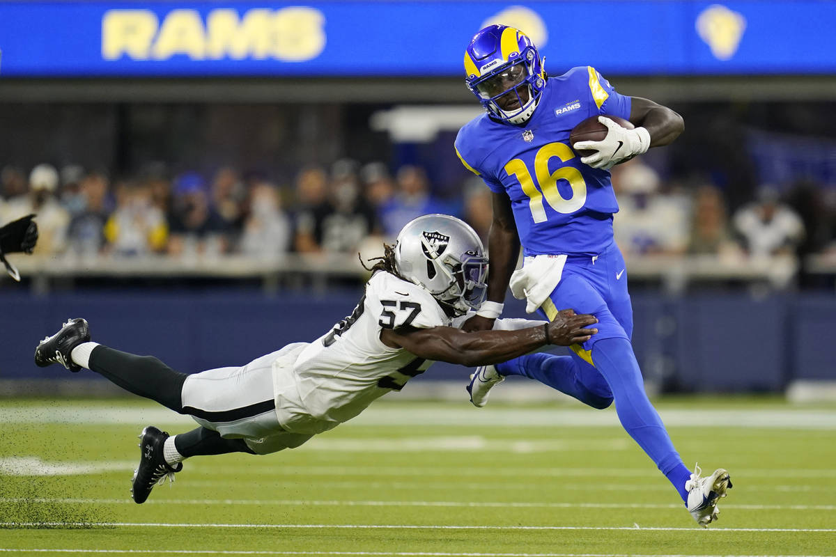 Los Angeles Rams quarterback Bryce Perkins, right, is tackled by Las Vegas Raiders linebacker A ...