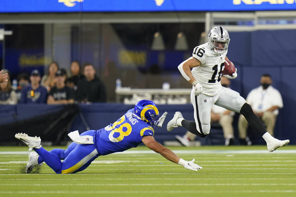 Las Vegas Raiders wide receiver Dillon Stoner (16) runs around Los Angeles Rams defender Brycen ...