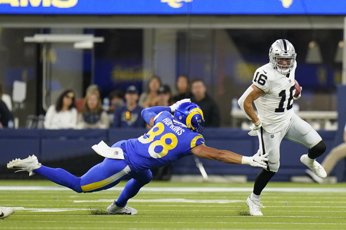 Las Vegas Raiders wide receiver Dillon Stoner (16) runs around Los Angeles Rams defender Brycen ...