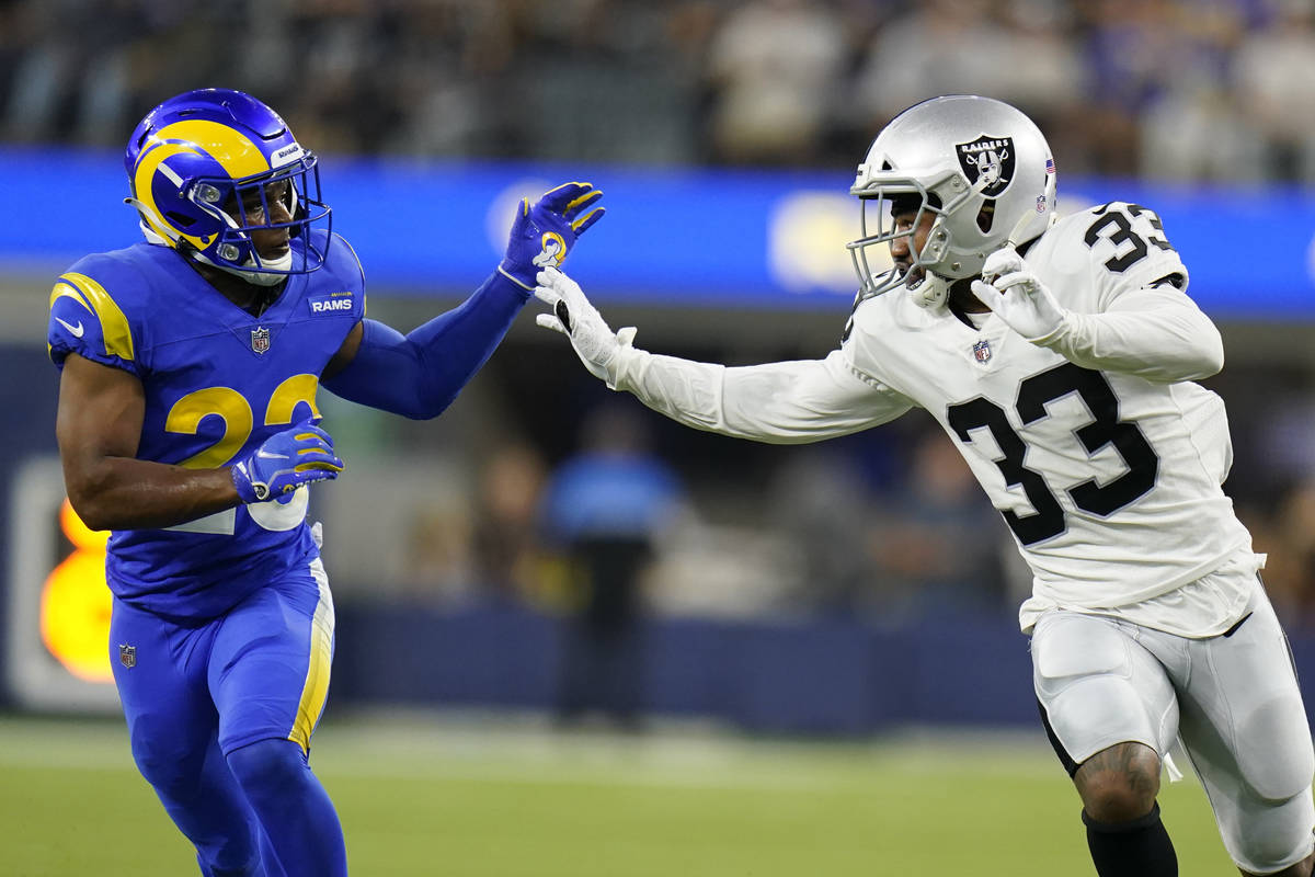 Las Vegas Raiders safety Roderic Teamer, right, runs against Los Angeles Rams defensive back Ju ...