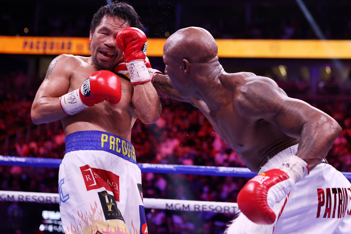 Yordenis Ugas, right, connects a punch against Manny Pacquiao in the sixth round of the WBA Wor ...