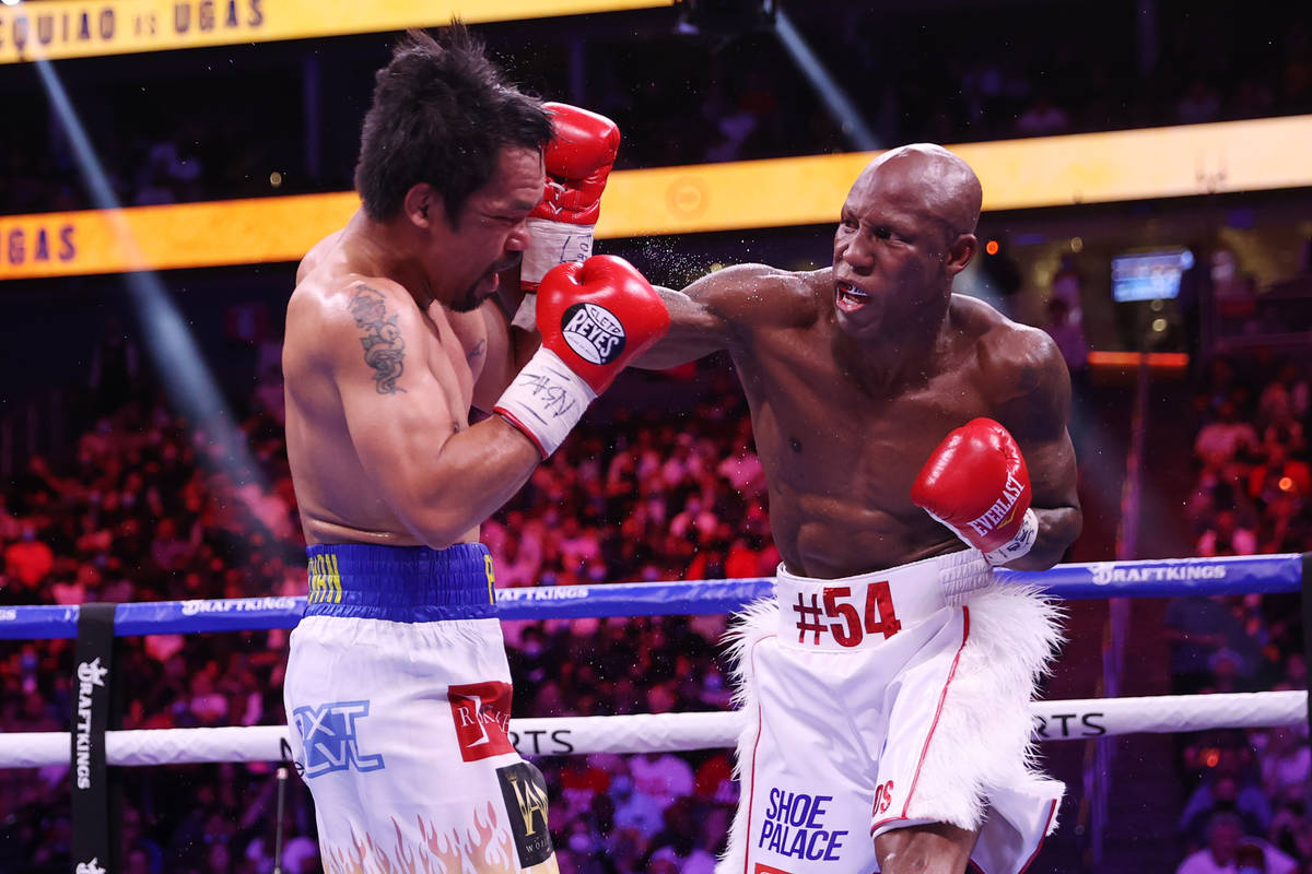 Yordenis Ugas, right, battles Manny Pacquiao in the fifth round of the WBA World Welterweight T ...