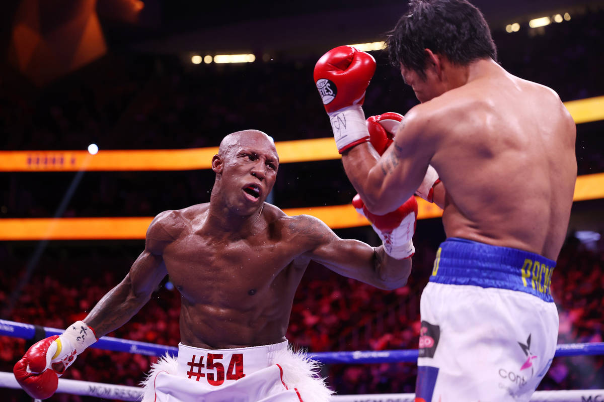 Yordenis Ugas, left, battles Manny Pacquiao in the fourth round of the WBA World Welterweight T ...