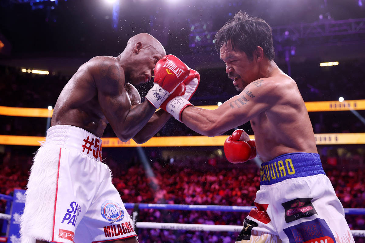 Yordenis Ugas, left, battles Manny Pacquiao in the sixth round of the WBA World Welterweight Ti ...