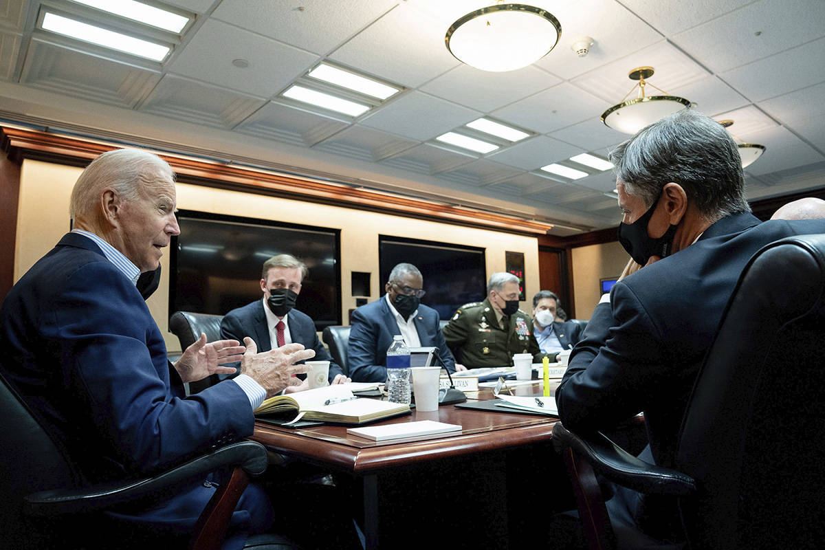 In this image released by The White House, President Joe Biden speaks with his national securit ...