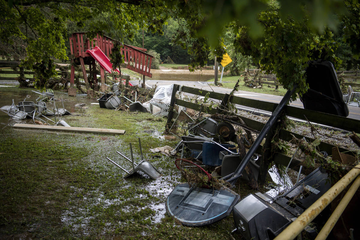 Debris from flooding is strewn along Sam Hollow Road following heavy rainfall on Saturday, Aug. ...