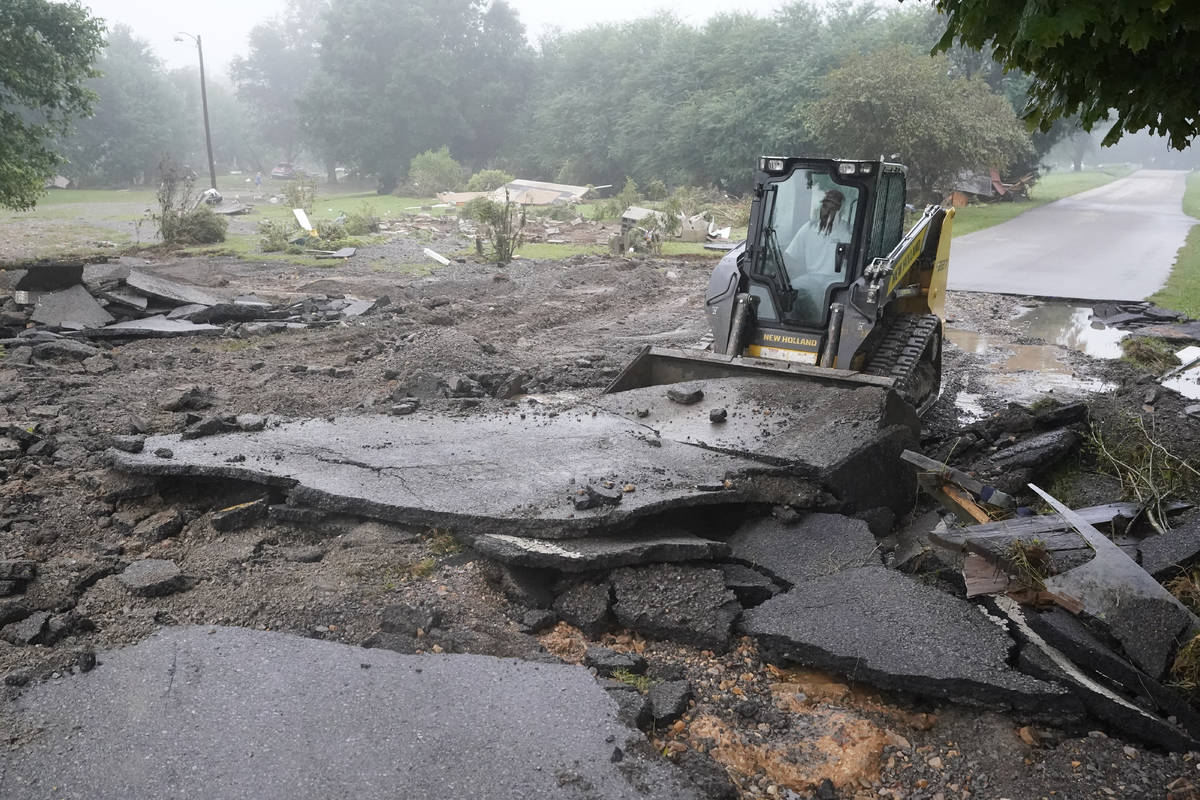 A road is repaired Sunday, Aug. 22, 2021, in McEwen, Tenn. The road was repaired Saturday after ...