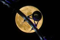 A full moon rises behind the High Roller observation wheel on the Strip in Las Vegas, Sunday, A ...