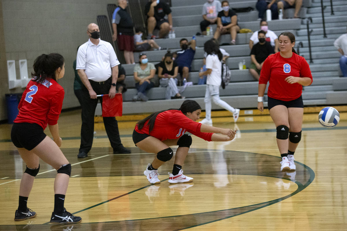 Western's Ashley Hipolito (11) bumps next to Mia Perez (8) during their high school volleyball ...