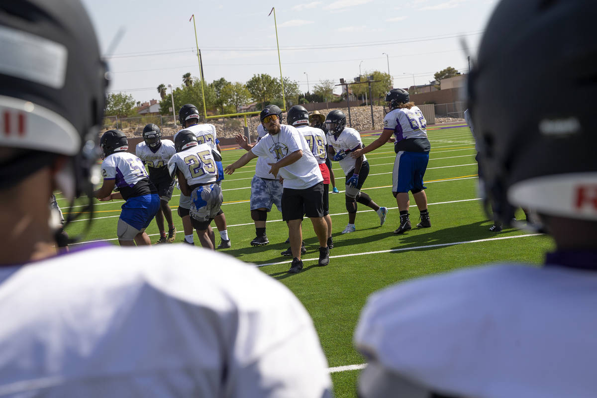 Head coach Joshua Bennett, center, leads varsity football team practice at Sunrise Mountain Hig ...