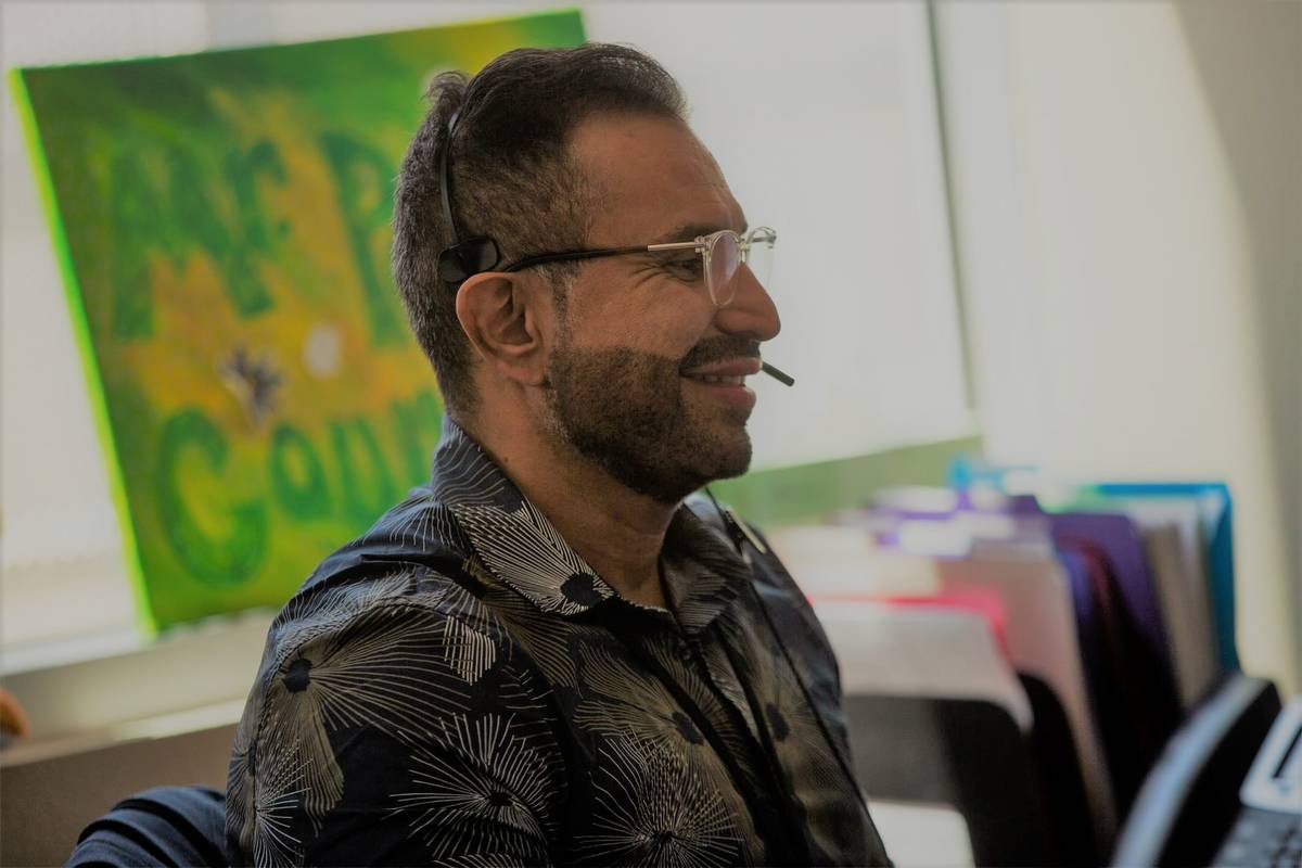 School counselor Mario Peraza, who serves grades 9 through 12, speaks with a parent on the phon ...