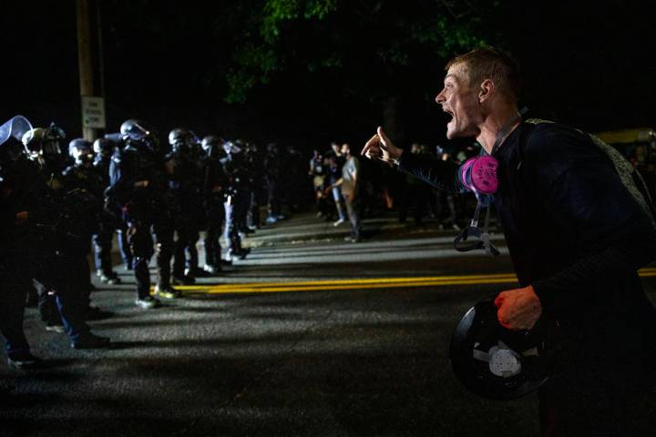 A protester screams at police in Portland, Oregon. (AP Photo/Paula Bronstein)