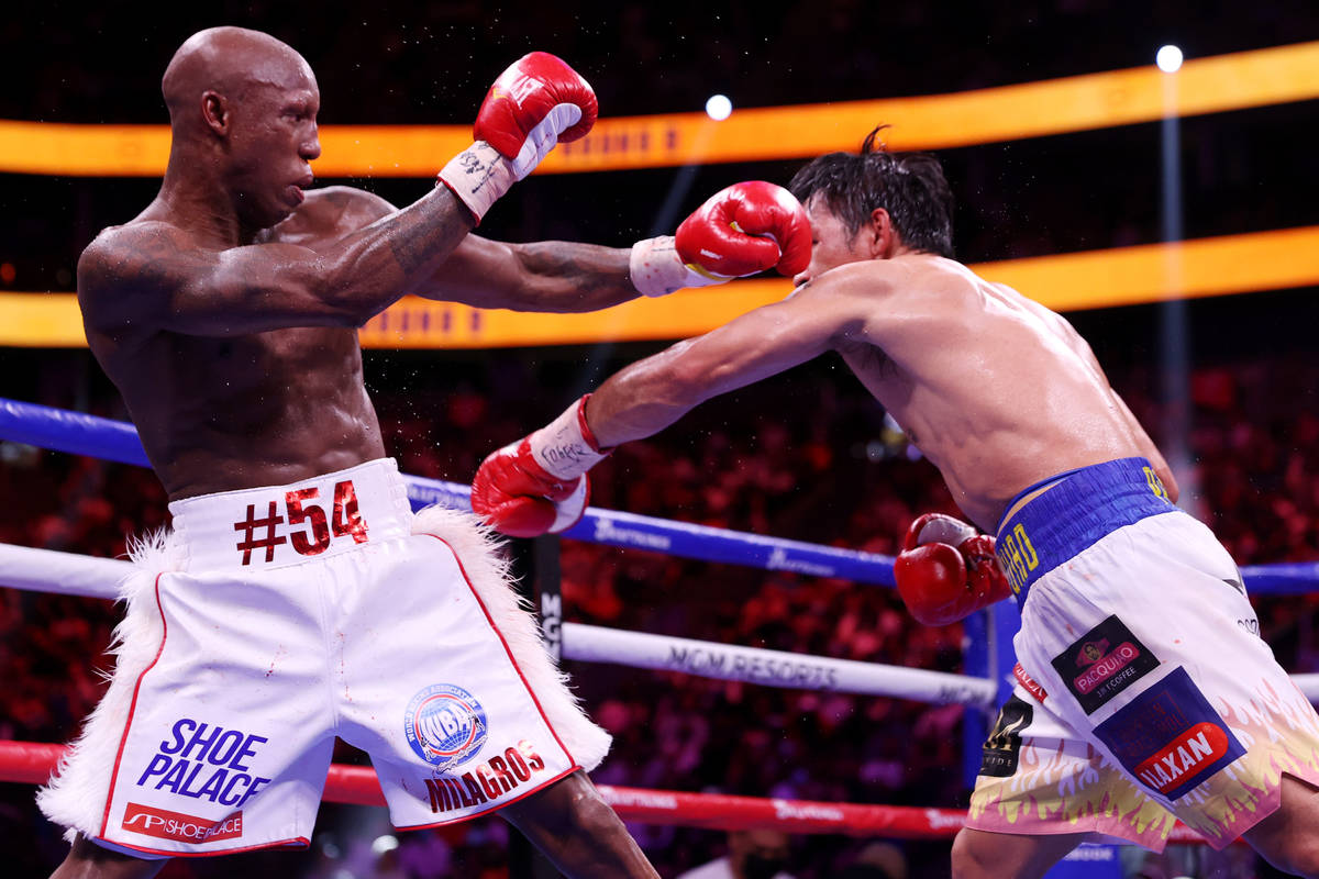 Yordenis Ugas, left, battles Manny Pacquiao in the ninth round of the WBA World Welterweight Ti ...