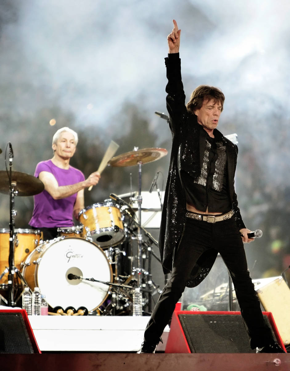 FILE - Mick Jagger, right, and drummer Charlie Watts, perform with the Rolling Stones at halfti ...