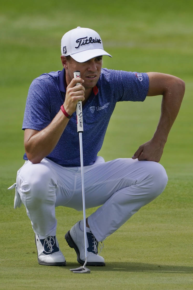 Justin Thomas lines up his shot on the second green in the final round at The Northern Trust go ...