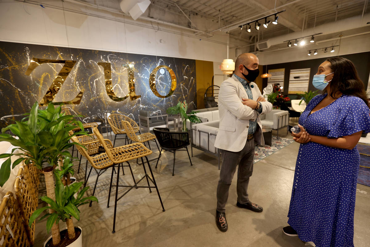 Luis Ruesga of Zuo Modern Contemporary talks to buyer Meg Donovan of San Francisco at the Las V ...
