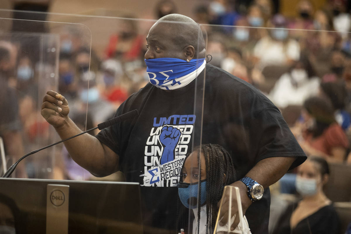 Joe McNelly of Las Vegas with his daughter Myla, 9, speaks during a Clark County School Distric ...