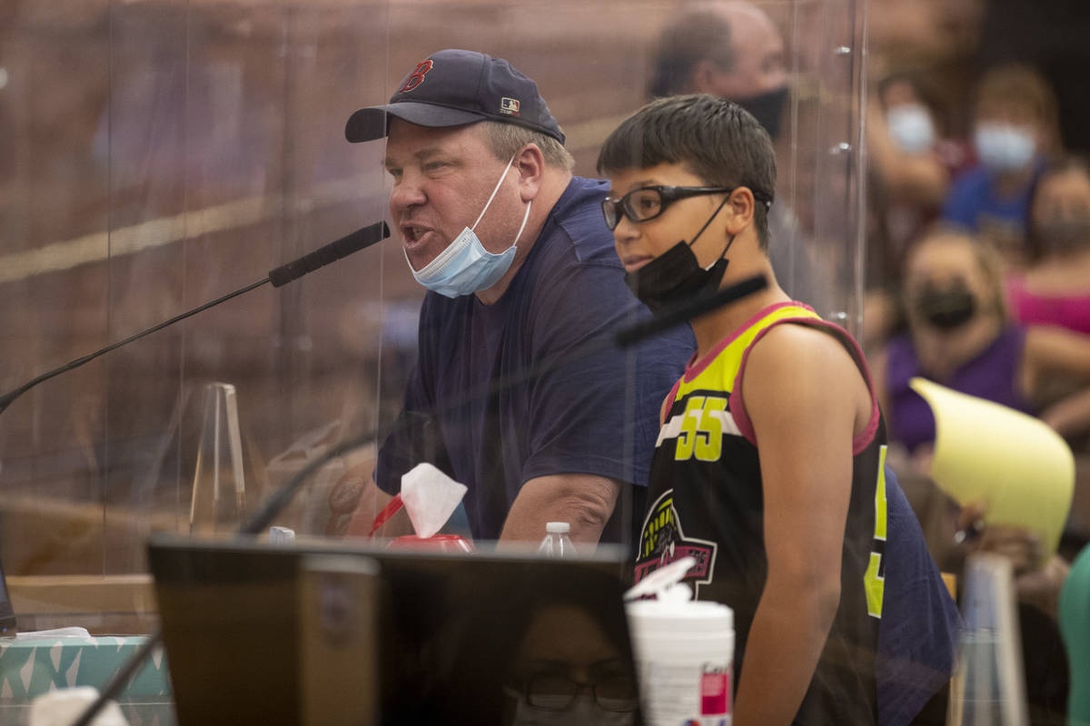 Dyer Lawrence of Las Vegas with his son Luke, 13, speaks during a Clark County School District ...