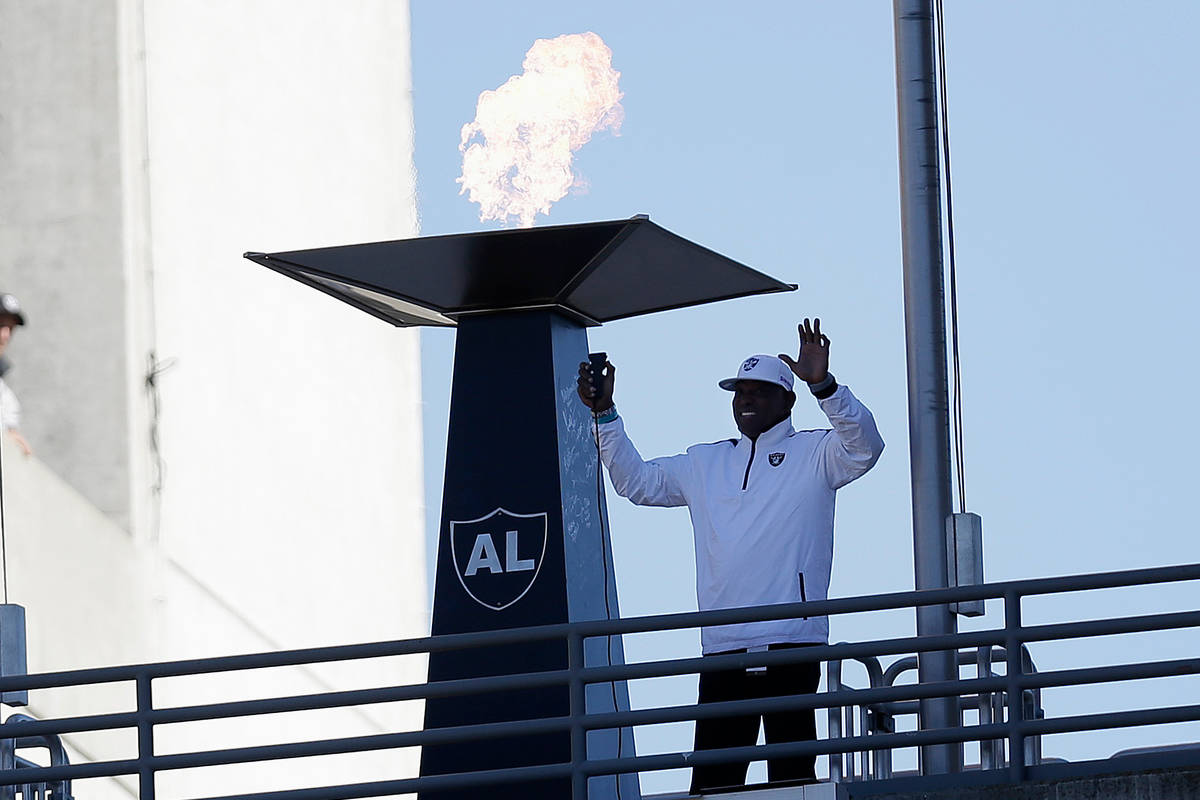 In this Nov. 4, 2012, file photo former Oakland Raiders wide receiver Cliff Branch lights a cer ...
