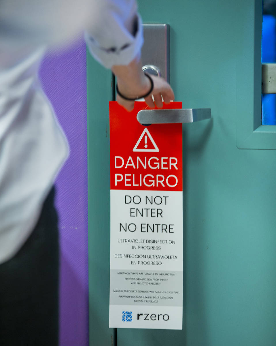 Warning placards are hung on doors when an R-Zero 372 Arc UV-C system is in use, the Clark Coun ...