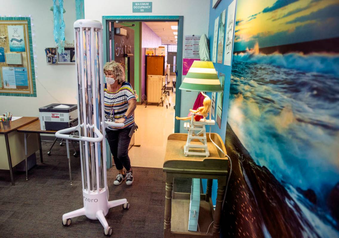 Support staff trainer Lisa Davis wheels in an R-Zero 372 Arc UV-C system as the Clark County Sc ...