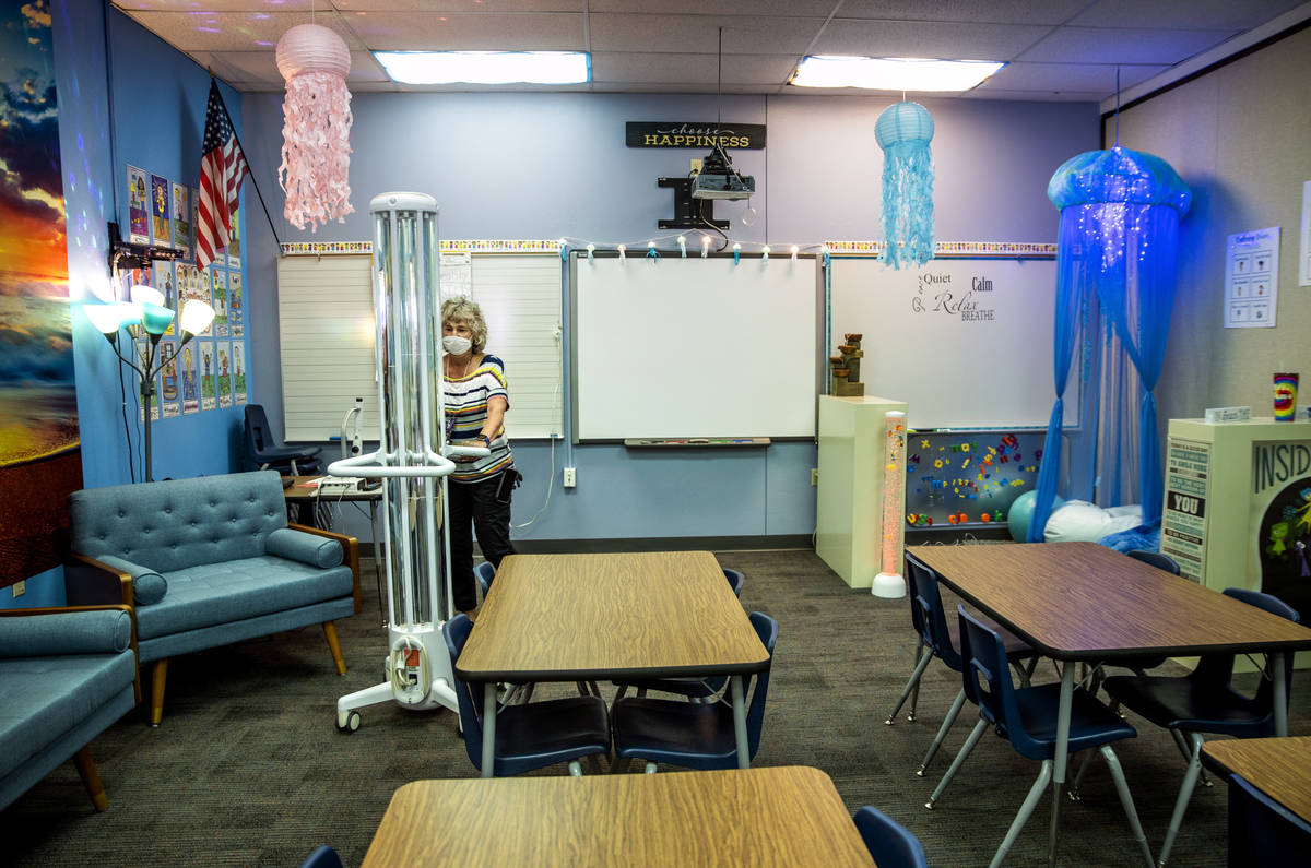 Support staff trainer Lisa Davis wheels out an R-Zero 372 Arc UV-C system as the Clark County S ...