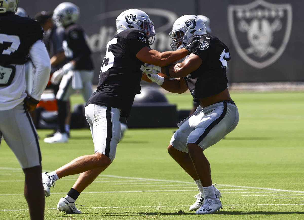 Raiders linebackers Tanner Muse, left,and Max Richardson participate in drills during training ...