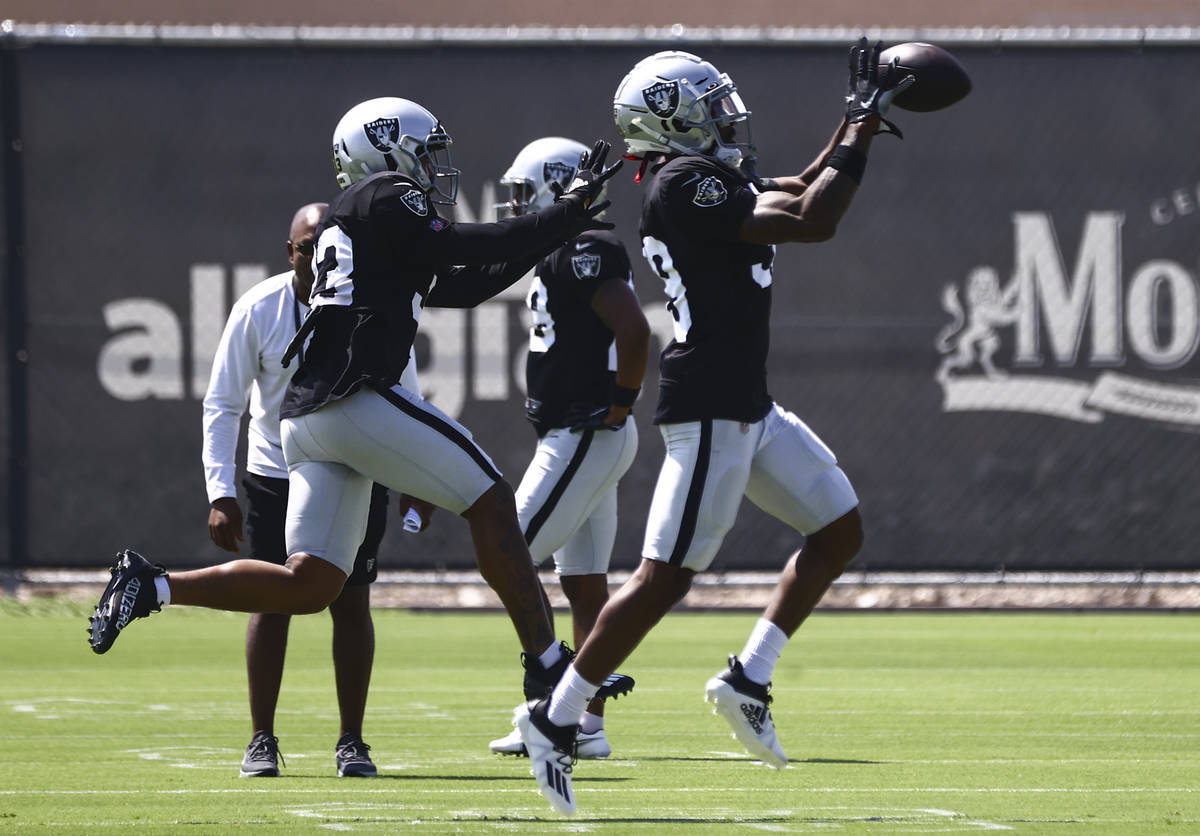 Raiders safety Roderic Teamer, left, and cornerback Nate Hobbs run through drills during train ...