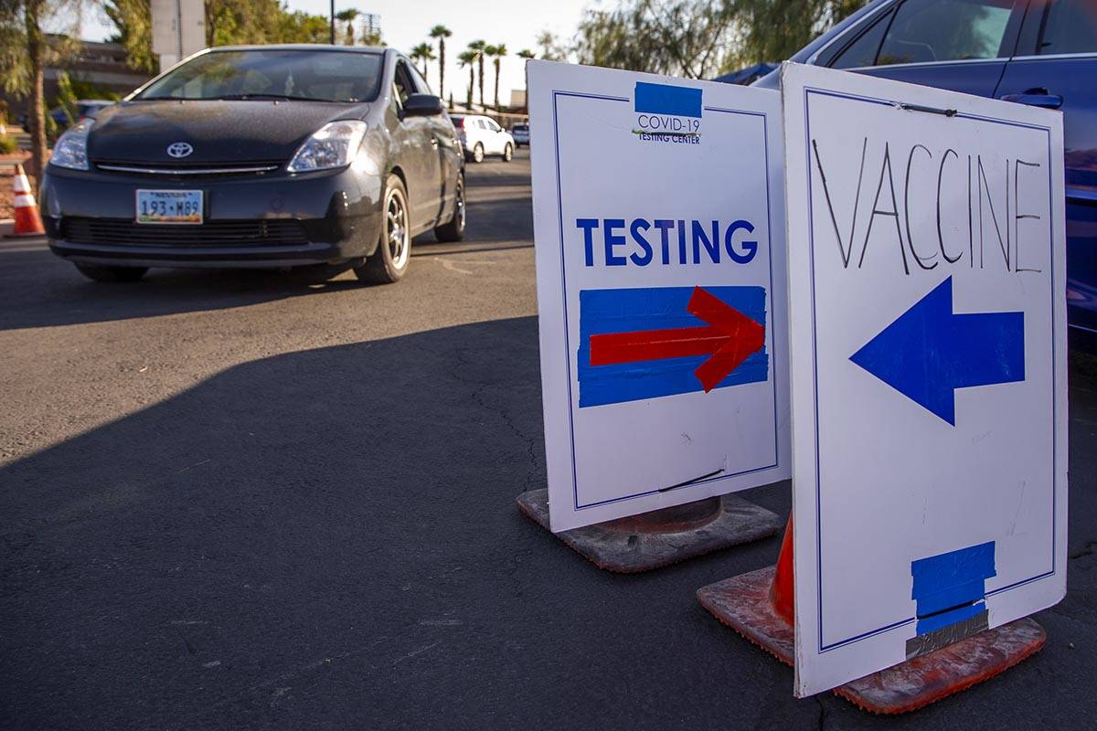 Cars are directed to specific lanes at the drive-thru COVID-19 tests and vaccinations site offe ...
