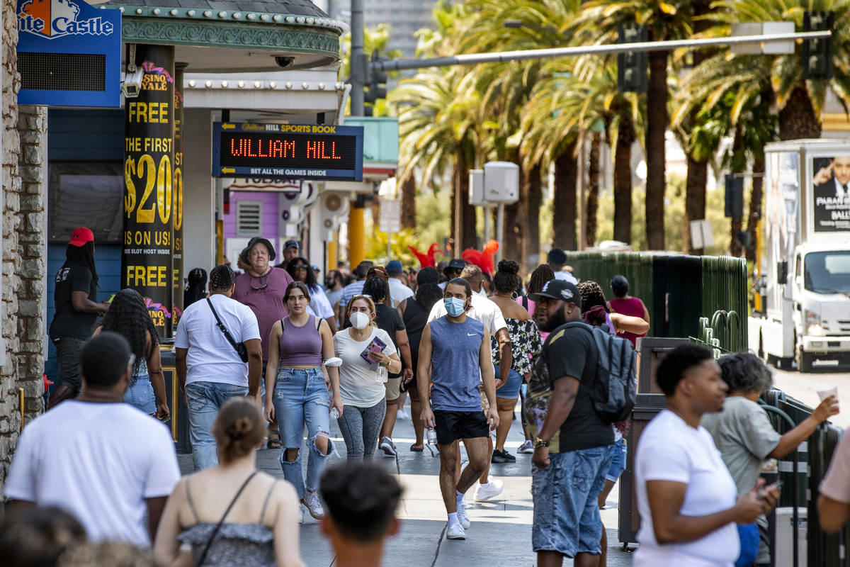 People walk along the Strip near The Venetian on Friday, July 16, 2021, in Las Vegas. The LVCVA ...