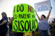 Protesters hold signs opposing the mask mandate for Clark County School District students on We ...