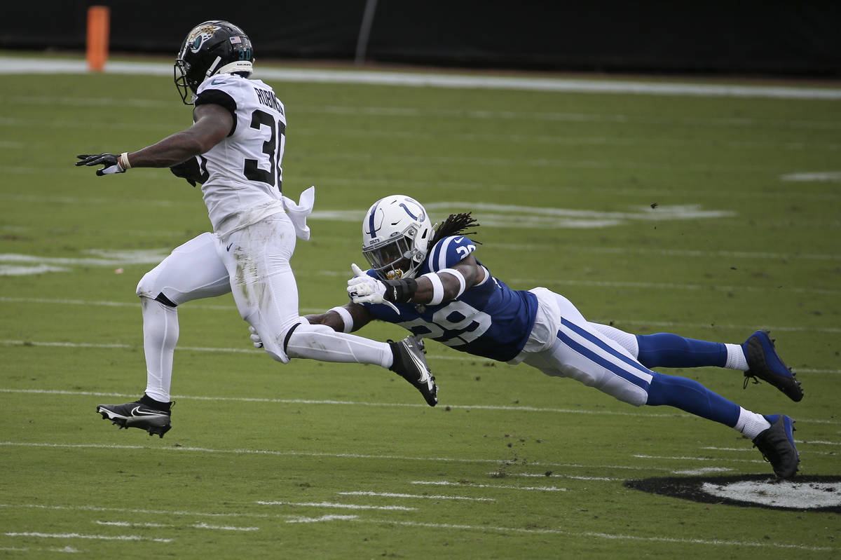 Jacksonville Jaguars running back James Robinson (30) slips past Indianapolis Colts free safety ...
