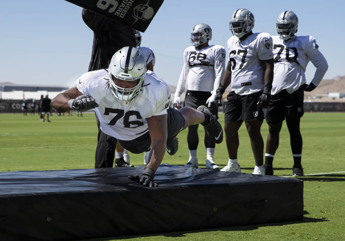 Raiders offensive guard John Simpson participates in drills during training camp at Raiders Hea ...