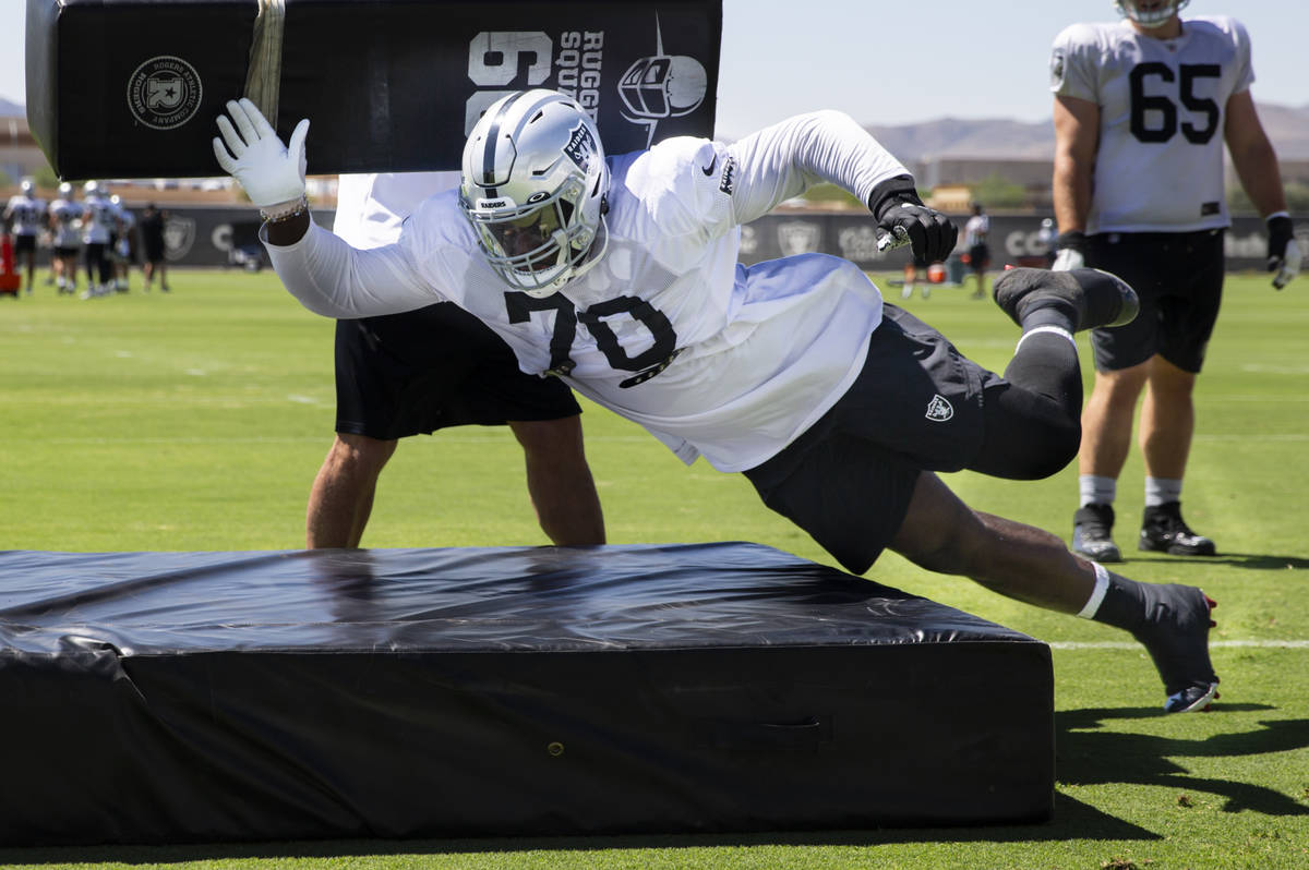 Raiders offensive tackle Alex Leatherwood participates in drills during training camp at Raider ...