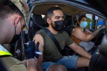 Nevada National Guard SPC Austin Czarnecki, left, gives a COVID-19 vaccination to Luis Gerardo ...