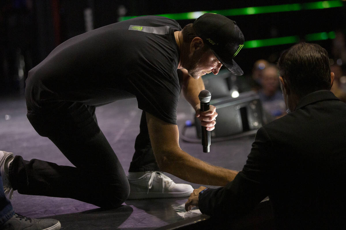 Kurt Busch, a NASCAR driver from Las Vegas, signs fan memoribilia during a fan event in The Sho ...