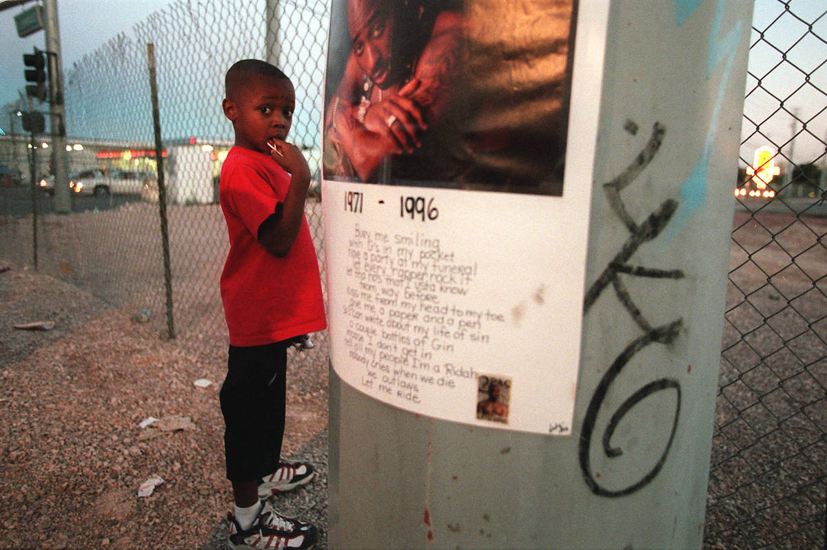 Kiondre Pollard, 6, stands next to a poster of Tupac Shakur before a vigil honoring the late hi ...