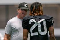 Raiders head coach Jon Gruden speaks to cornerback Damon Arnette (20) during their NFL training ...