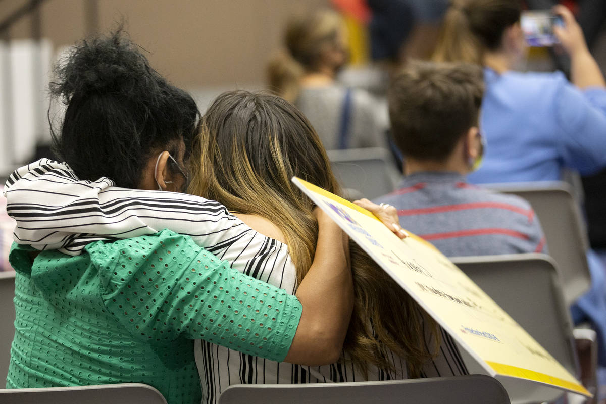 Audrey S. hugs a loved one while holding her check for $100,000 during the final Vax Nevada Day ...