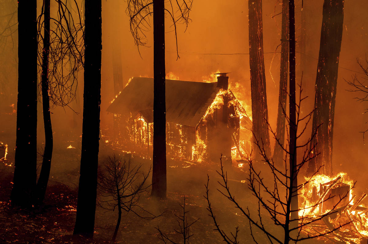 Flames from the French Fire consume a cabin on Highway 155 in Sequoia National Forest, Calif., ...