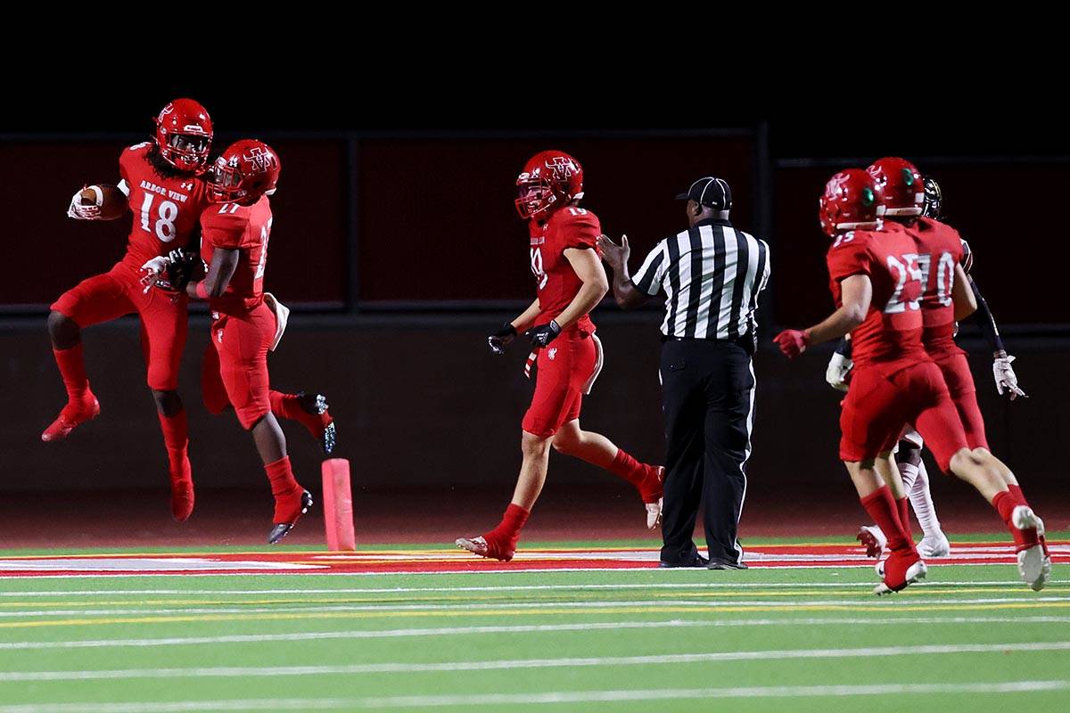 Arbor View's David Washington (18) celebrates a touchdown with Makhai Donaldson (27) during the ...