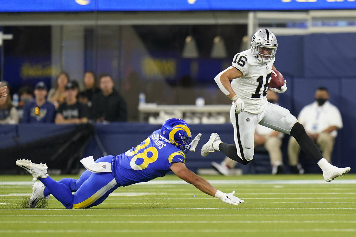 Las Vegas Raiders wide receiver Dillon Stoner (16) runs around Los Angeles Rams defender Brycen ...