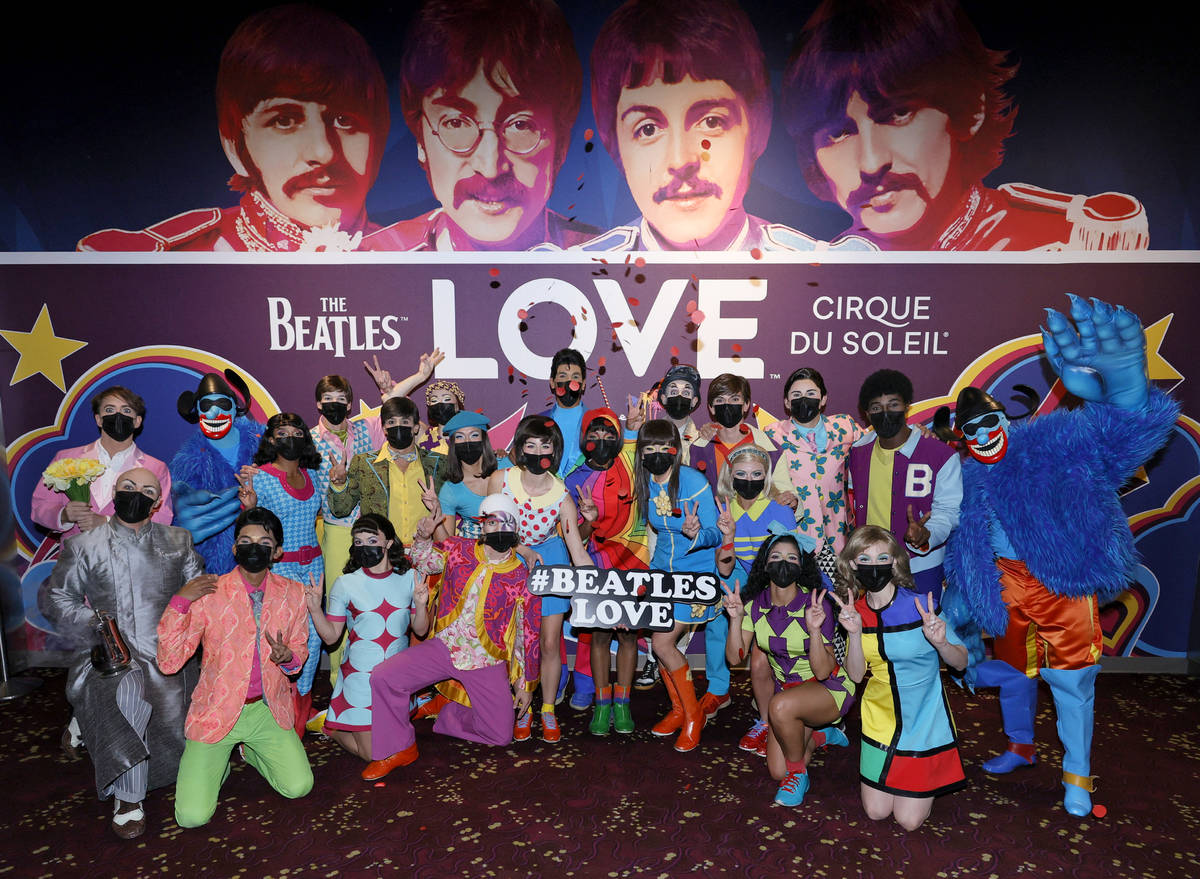 Cast members pose during a pop-up performance before the grand reopening of "The Beatles LOVE B ...