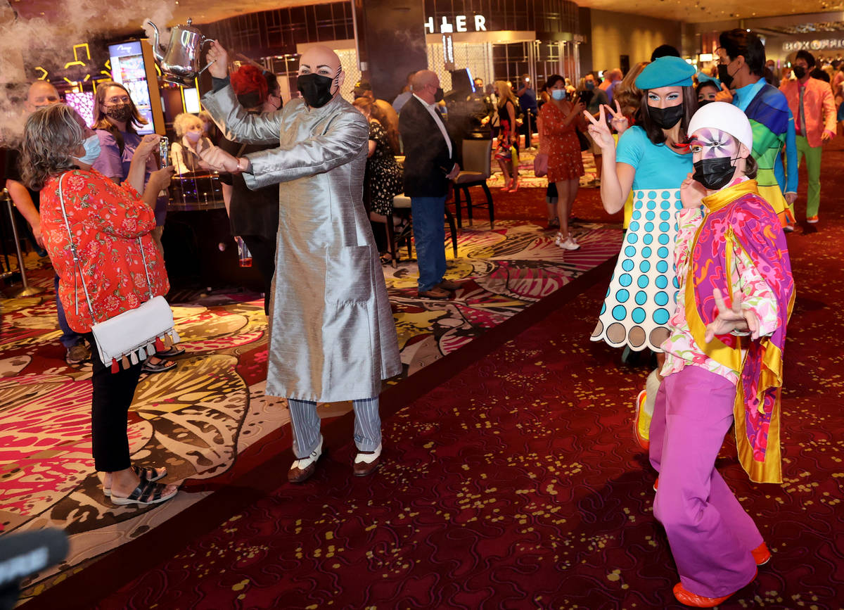 The cast of The Beatles LOVE entertain guests, employees, and fans during a celebratory pop-up ...